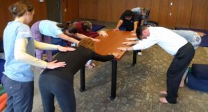 students practicing downward facing dog