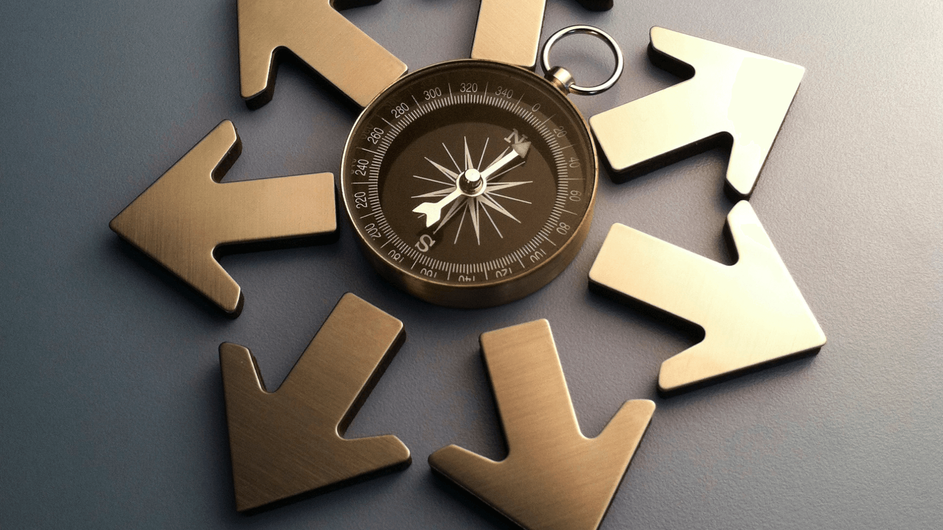 A compass surrounded by 7 golden metal arrows pointing away from it