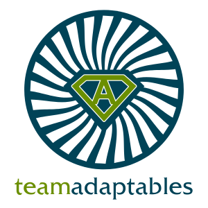 A circle with teal spokes radiating out from a green, stylized letter "A". Text reading "Team Adaptables" below the circle