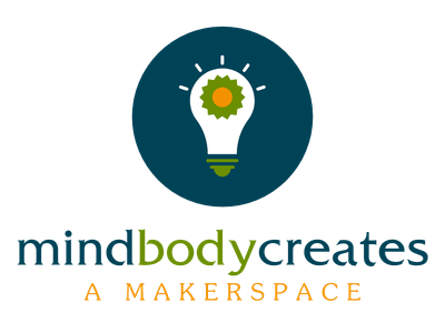 A dark blue circle containing a lightbulb. Text reading Mind Body Creates, A Makerspace